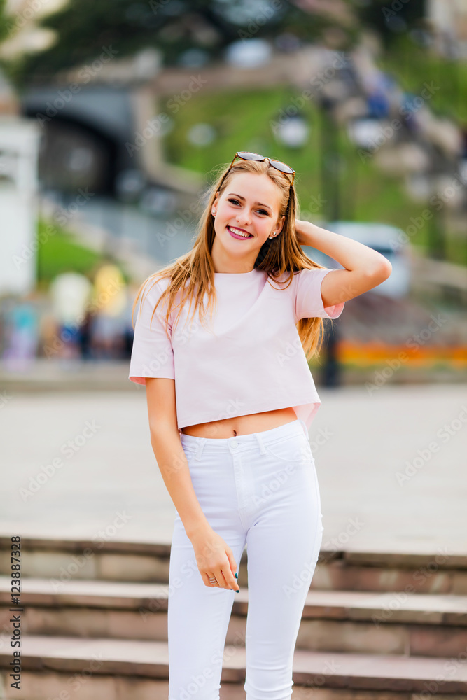 Happy positive summer portrait of cute sexy woman on the summer street