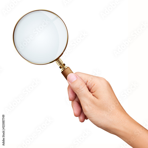Hand holding golden magnifying glass isolated on white backgroun
