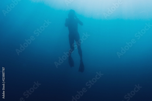 Underwater silhouette of freediver