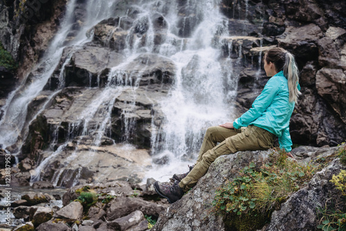 Woman enjoying view of waterfall