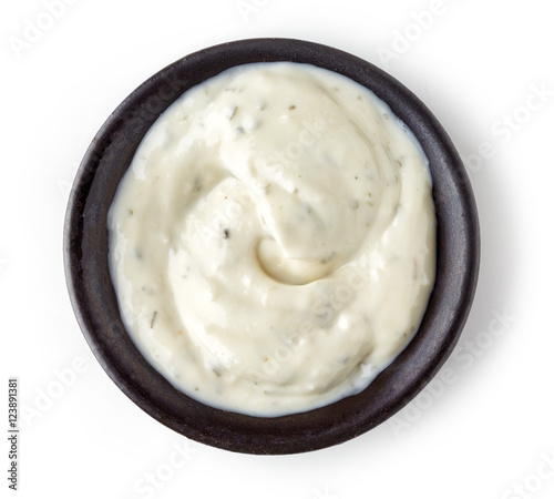 Obraz na plátne Garlic sauce  in round dish on white background