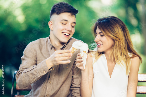 man and woman sitting eating ice cream