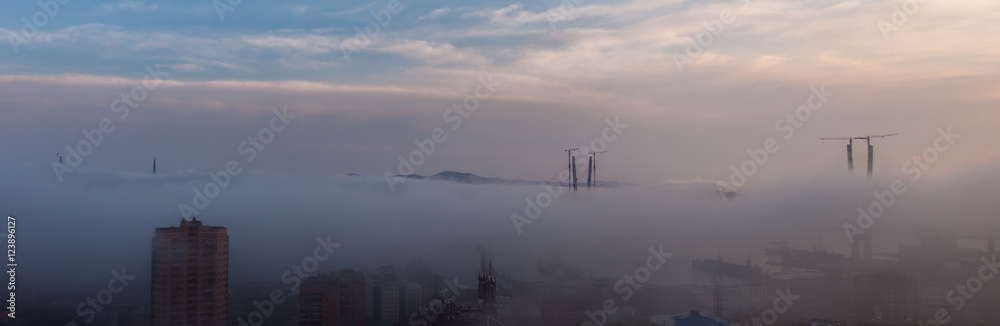 Vladivostok cityscape. Foggy day. Construction of the bridge. Vladivostok cityscape. Foggy day. Construction of the bridge.