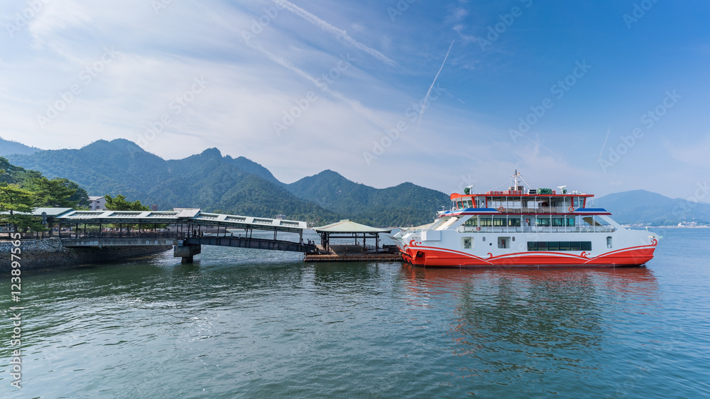Fototapeta premium Pasażerowie wysiadają z promu w Terminalu Promowym Miyajima na wyspie Miyajima, Hiroszima, Japonia