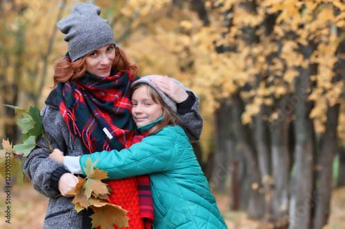 family woman and daughter walk autumn park