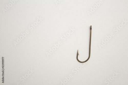 Fishing hook on a white paper background