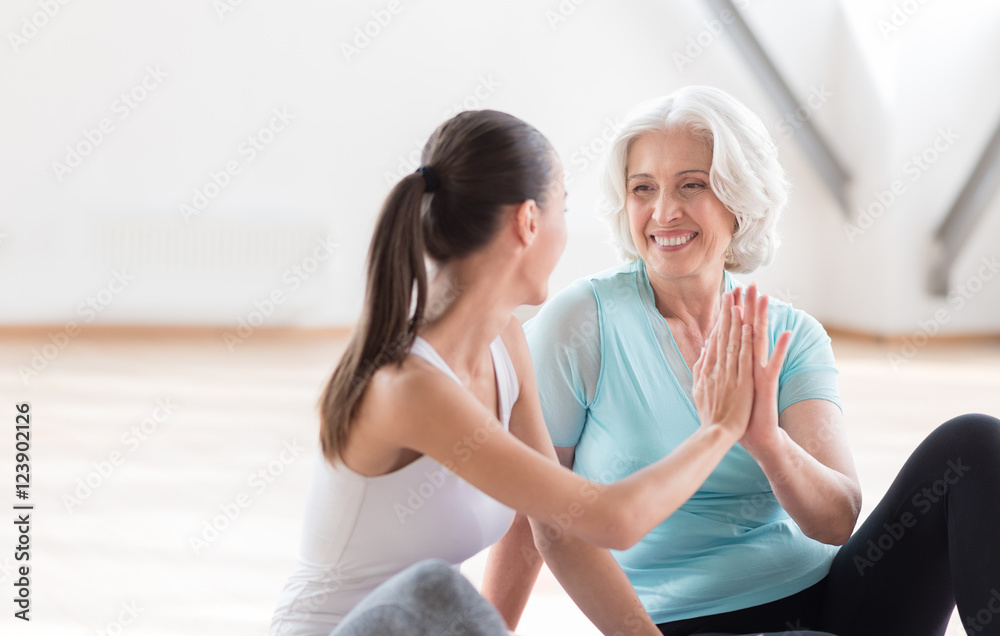 Joyful pleasant women doing high five Joyful pleasant women doing high five