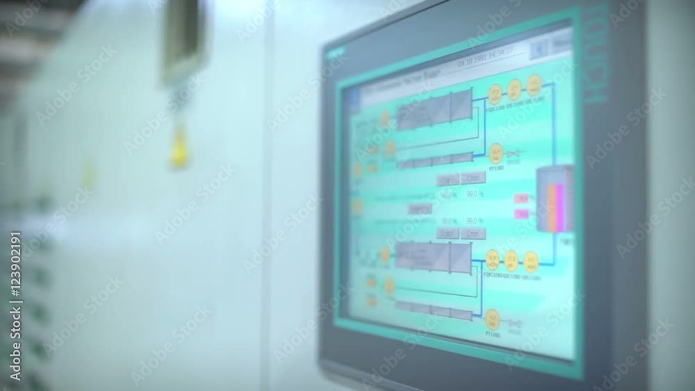The sensor control at the factory. Modern production. Lab in a sterile gown manages production processes remote. The Danger . Remote Control Panel. Starting equipment factory The sensor control at the factory. Modern production. Lab in a sterile gown manages production processes remote. The Danger . Remote Control Panel. Starting equipment factory