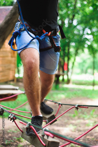 Hiking in the rope park beautiful sports guy