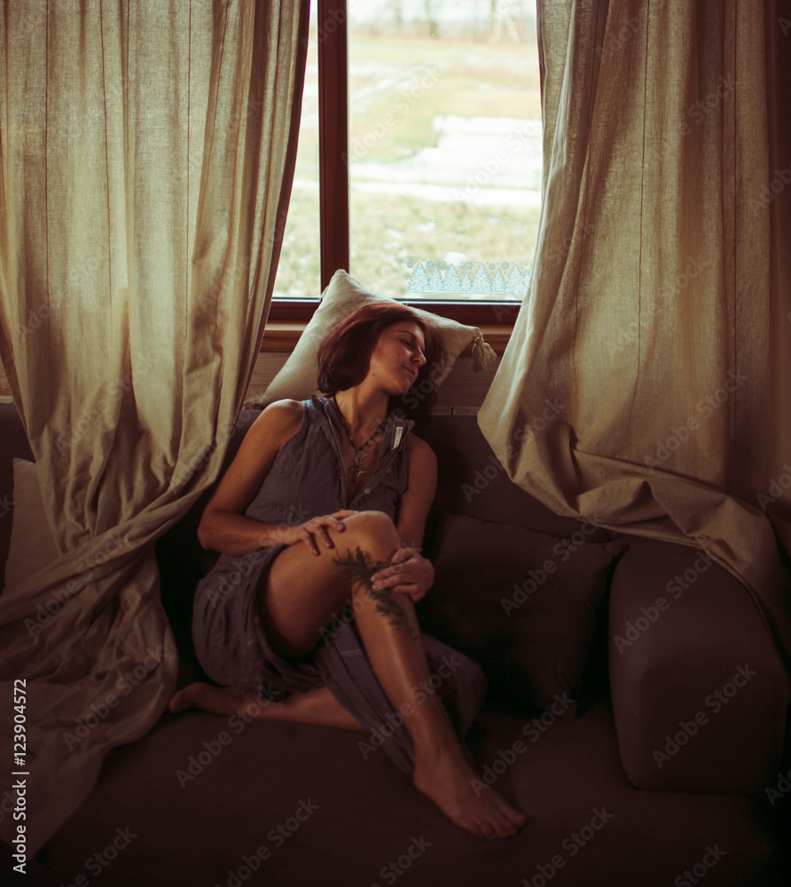 Obraz premium Girl relaxing near the window