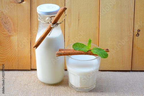 Almond milk with almond on a wooden table
 photo