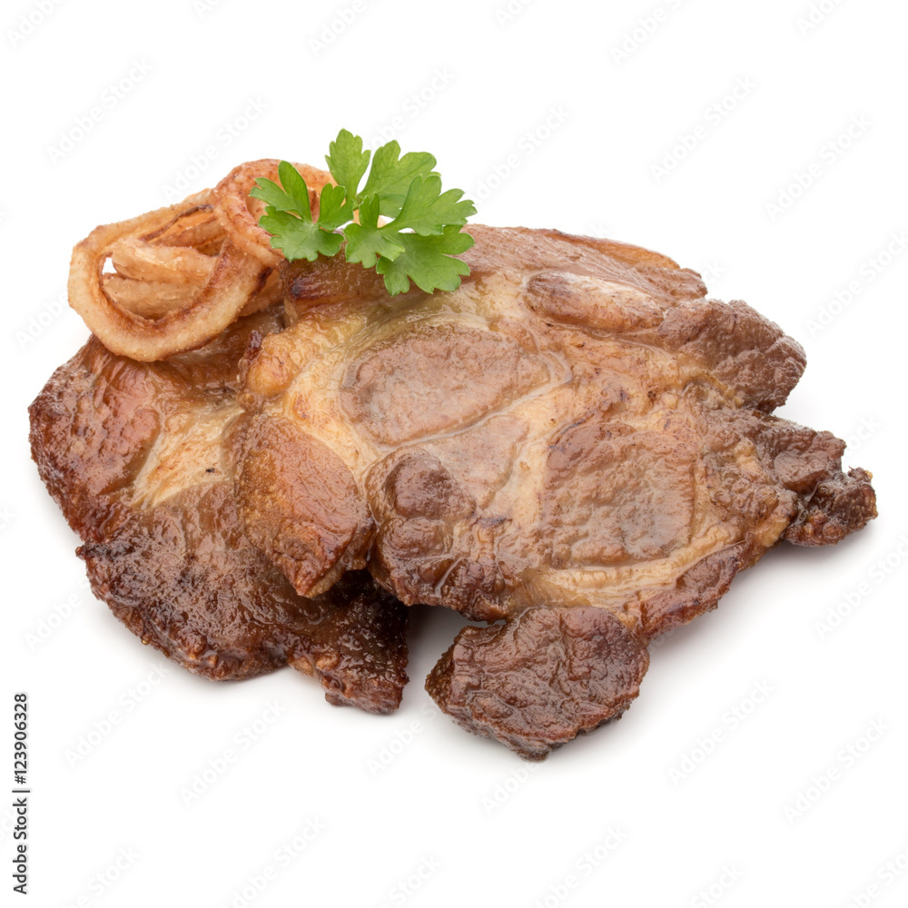 Cooked fried pork meat with parsley herb leaves and onion slices