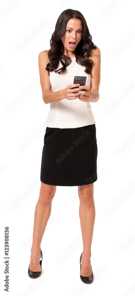 Full-length stylish young woman surprised with mouth open texting holding mobile phone isolated on white background Full-length stylish young woman surprised with mouth open texting holding mobile phone isolated on white background