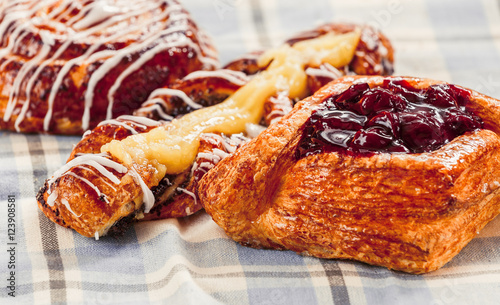 pastries, buns, custard cake, a glass of milk on the table. Close-up photo