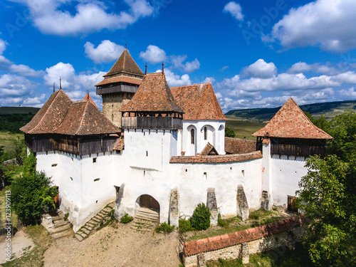 Viscri fortified Chruch in the middle of Transylvania, Romania. Aerial view from drone. Important tourist attraction. photo
