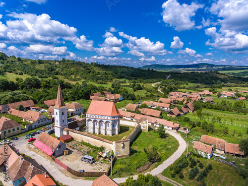 The fortified church Cloasterf. Traditional saxon village in Transylvania, Romania. Aerial view from a drone. HDR image. photo