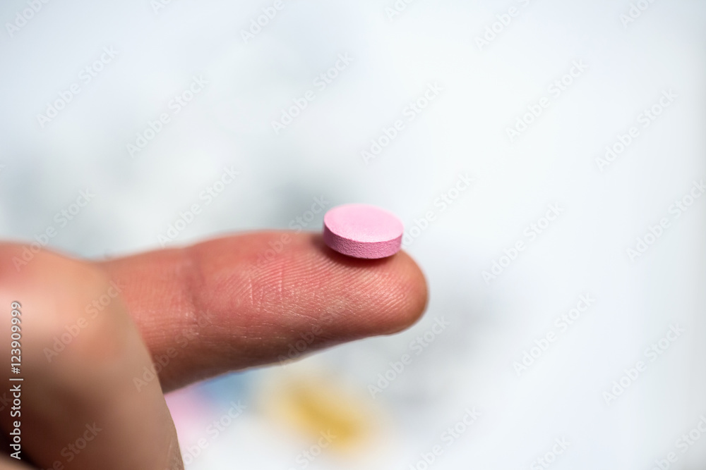Keep the pink pill on the hand close up. Keep the pink pill on the hand close up.