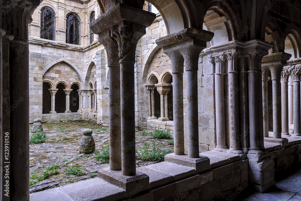 sight of the columns, arches and capitals of the courtyard of the cloister of the Romanesque abbey of Santa Maria the Real one in aguilar of Campoo, Palencia, Spain