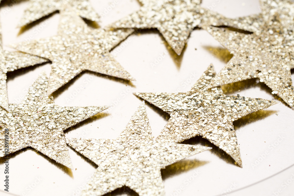 Christmas gold stars decoration on abstract background.
