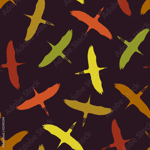 Seamless pattern with color silhouettes of сranes birds. Vector autumn background.
