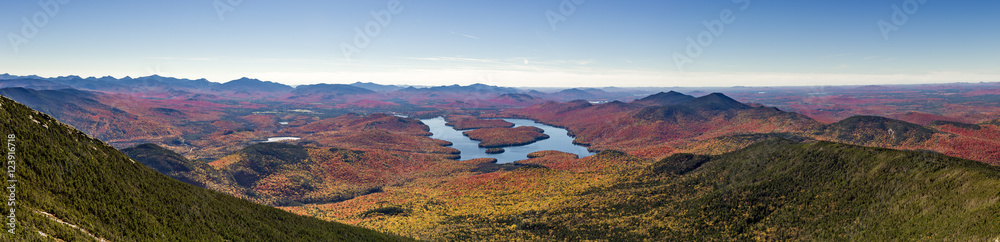 Fototapeta premium Panoramic view of the Adirondack Mountains featuring Lake Placid on a sunny autumn day as seen by looking south west from the summit of Whiteface Mountain in Wilmington, New York