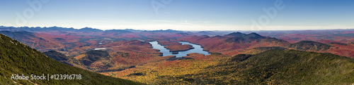 Panoramic view of the Adirondack Mountains featuring Lake Placid on a sunny autumn day as seen by looking south west from the summit of Whiteface Mountain in Wilmington, New York