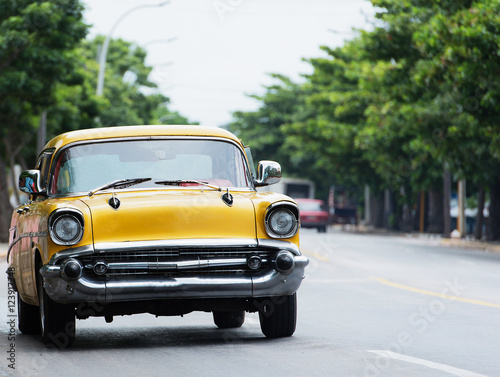Yellow American Classic car on street in Havana Cuba