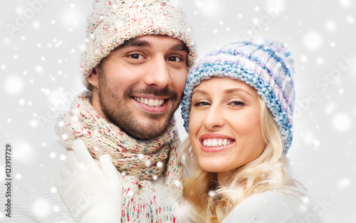 smiling couple in winter clothes hugging