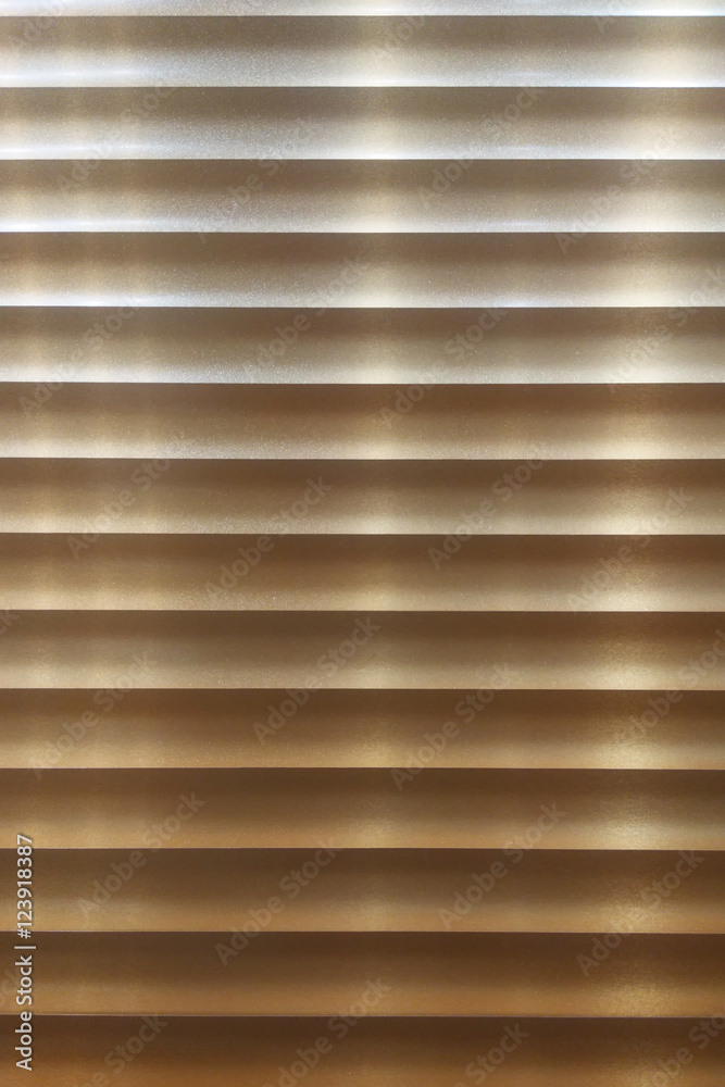 Obraz premium Closeup of wooden slats of a blind with natural sunshine shining