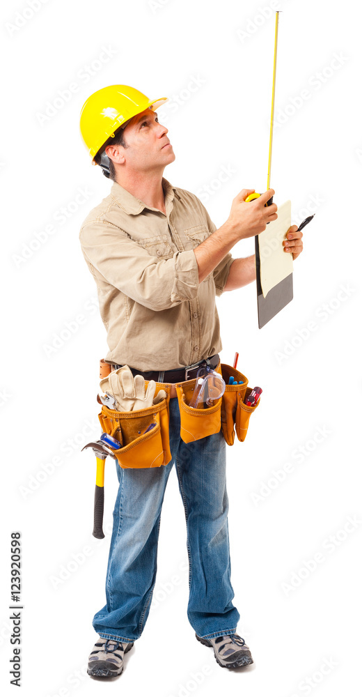 Full-length construction worker building contractor carpenter with tool belt and hard hat and clipboard measuring isolated on white background Full-length construction worker building contractor carpenter with tool belt and hard hat and clipboard measuring isolated on white background
