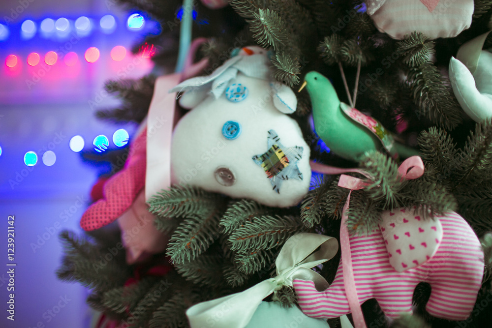 Toy elephants and snowman hang from the Christmas tree