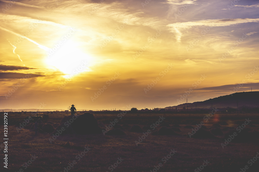 image silhouettes of farmers working in sunset