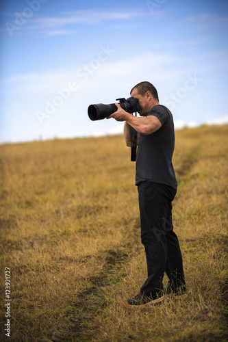 Professional wildlife photographer with equipment