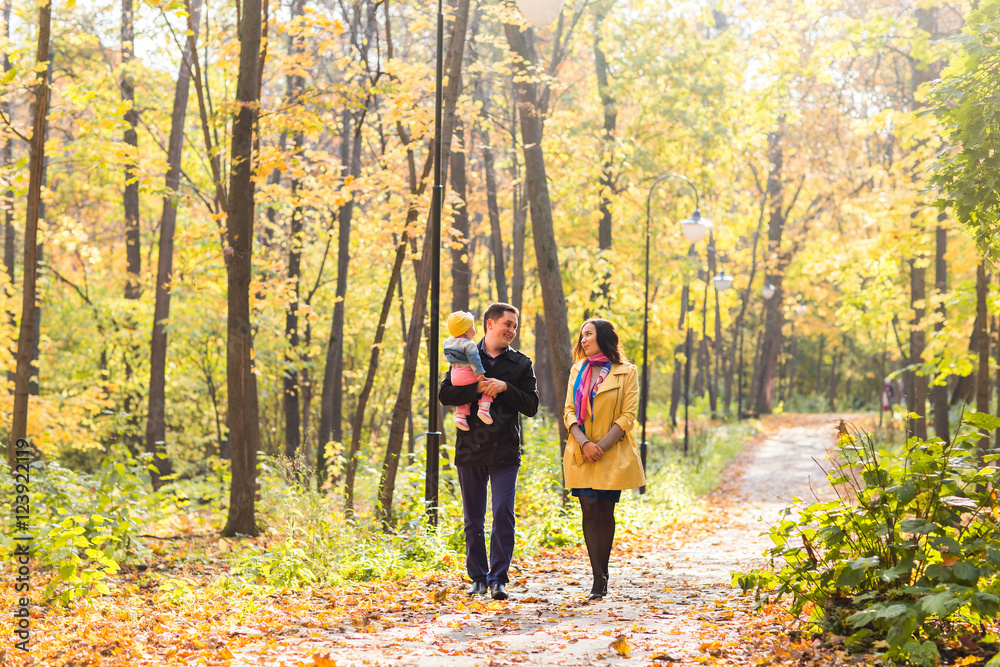 love, parenthood, family, season and people concept - smiling couple with baby in autumn park love, parenthood, family, season and people concept - smiling couple with baby in autumn park