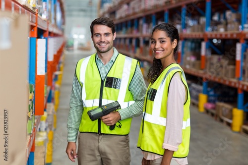 Canvas Print Portrait of smiling warehouse workers scanning box