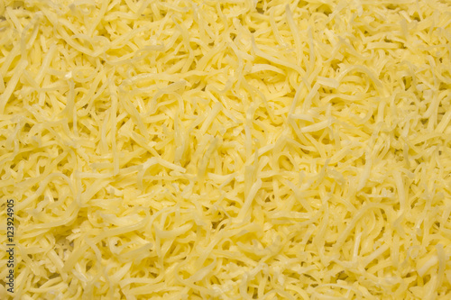 Heap of Grated pizza cheese close up texture