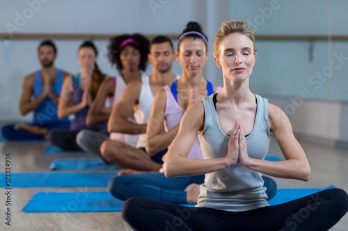 Group of people performing yoga