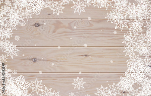white snowflakes on the wooden background