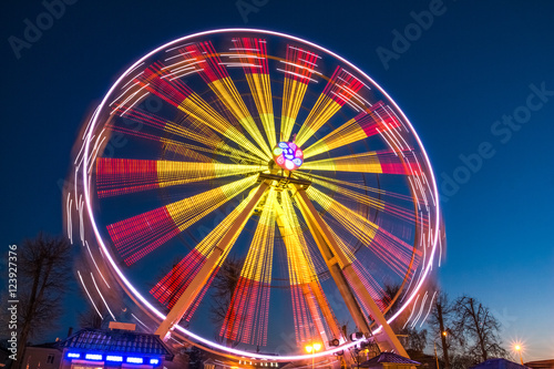 Ferris wheel at slow shutter speeds with a blue sky