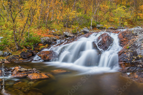 Fototapeta Naklejka Na Ścianę i Meble -  Small waterfall in autumnal landscape