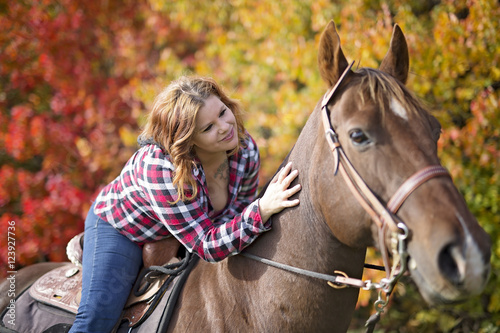 Beautiful and natural adult woman outdoors with horse © Louis-Photo