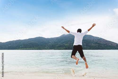 Happiness of businessman jumping relax on beautiful sea beach at © pongsakorn_jun26