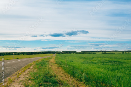 Motorway open road among fields Landscape with cloudy sky © Zayne C.
