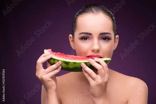 Beautiful woman eating tasty watermelon