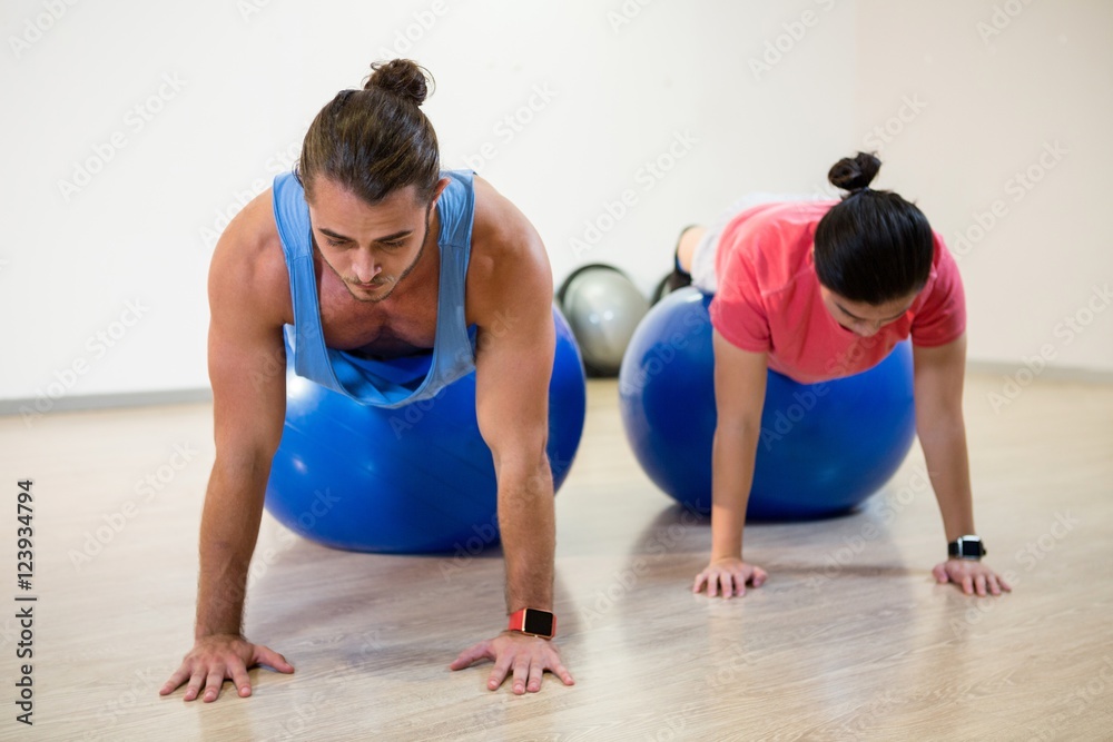 Men doing push-up on exercise ball Men doing push-up on exercise ball