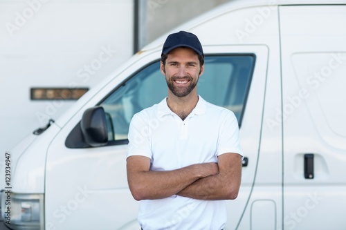 Portrait of delivery man standing with arms crossed  photo