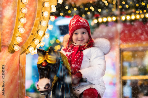 Child riding carousel on Christmas market © famveldman