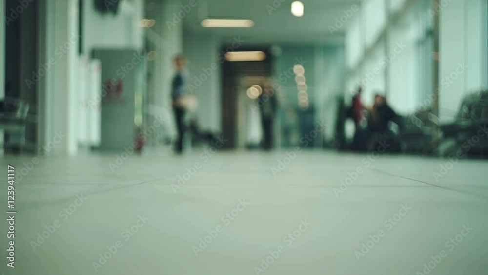 Passenger with luggage at a modern Station. woman walking with travel bag at the airport. with bokeh Passenger with luggage at a modern Station. woman walking with travel bag at the airport. with bokeh