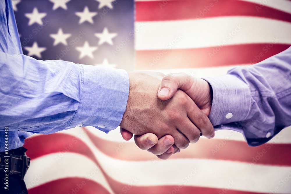 Composite image of two men shaking hands