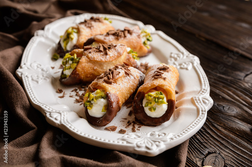 Traditional Sicilian cannoli stuffed with ricotta and pistachios
